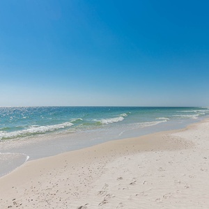 Experience the serene beachfront with soft sand and gentle waves, perfect for a relaxing getaway to Seawind