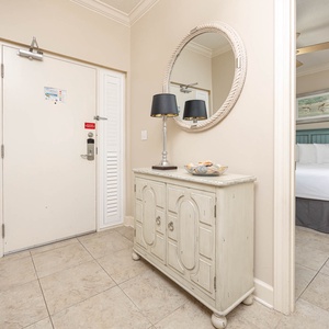 Welcoming entryway featuring coastal decor, a stylish mirror, and a charming console table for your convenience