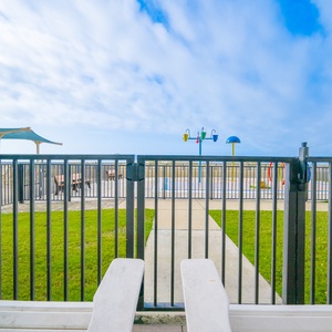 Enjoy the inviting outdoor space with a pool, lounge chairs, and playful splash park for family fun