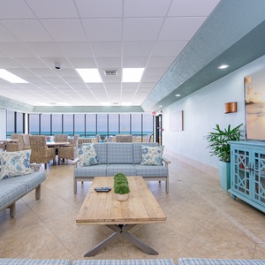Relax in this inviting lounge with beach views, comfortable seating, and a cozy atmosphere perfect for unwinding