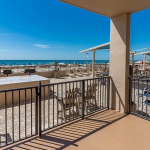 Step onto the spacious outdoor area with seating, perfect for enjoying the refreshing breeze and nearby beach views