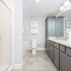 Experience a refreshing start to your day in this elegant master bath, enjoying the spacious shower and soothing tub