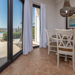 Dine at the round table with a view of the pool, surrounded by natural light from large sliding doors