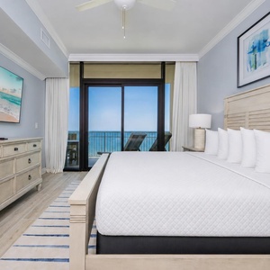 Inviting king master suite framed by stunning beach views and stylish accents