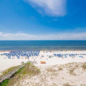Impressive view of sunny beach and turquoise waters from the balcony, perfect for relaxing in the sun