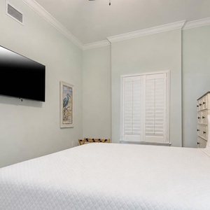 Relax on the cozy king bed in this guest suite and stream your favorite shows after a beach day