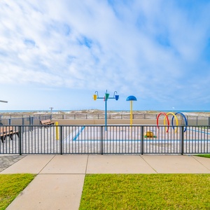 Relax at the outdoor patio area, enjoying views of the splash park, beach, and pool area just steps from your door