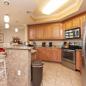This kitchen features granite countertops, stainless appliances, and a cozy breakfast bar, perfect for morning coffee