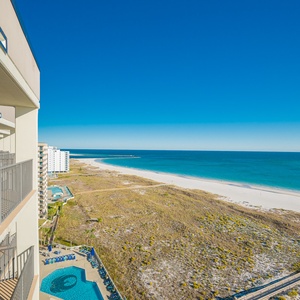 Balcony view showcases the tranquil gulf waters and white sand beach, perfect for relaxation and enjoying the coastal breeze