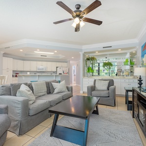 Unwind on the plush sofas, enjoying the warmth of relaxation while surrounded by coastal vibes and inviting decor