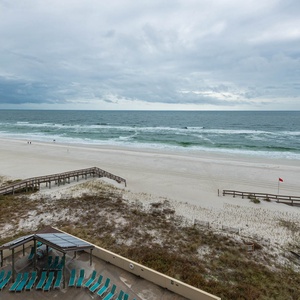 Relax with breathtaking views from the balcony overlooking the sandy beach and tranquil waves, perfect for your retreat