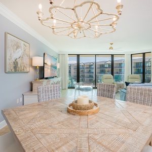 Gather around the intricately designed table and enjoy the inviting space filled with coastal light and charm