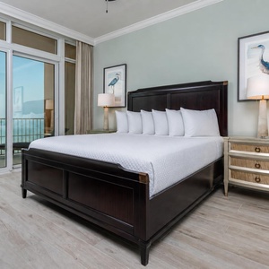 Retreat to the king master suite with cozy bedding and drift off to the sound of the waves from the balcony