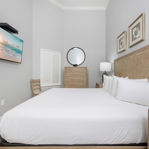 Guest bedroom featuring a king bed, wall-mounted TV, and stylish decor for a relaxing getaway