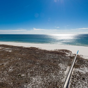 Gulf views stretch across the white sand beach, inviting relaxation and enjoyment from the balcony's vantage point