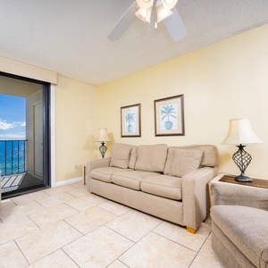 Inviting living room featuring cozy seating, queen sofa-sleeper, and a breathtaking view beyond the balcony