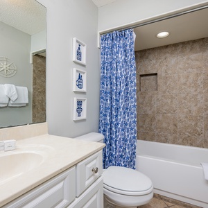 Freshen up in this guest bath in the relaxing shower or soothing tub before an exciting beach day
