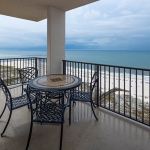 Relax on the balcony while taking in the tranquil views of the water and beach below
