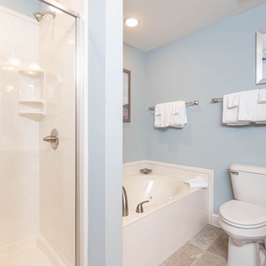 Indulge in relaxation in the master bath with a refreshing walk-in shower and soothing jetted tub