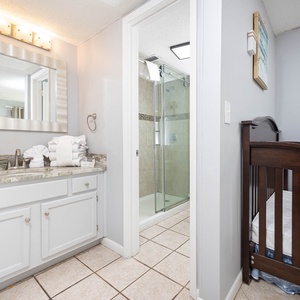 The master bath features a stylish vanity with a large mirror, a walk-in shower, and fresh towels for a refreshing retreat