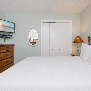 Enjoy a restful sleep on a queen bed, with a TV ready for your favorite show, in this guest room with a twin bunk