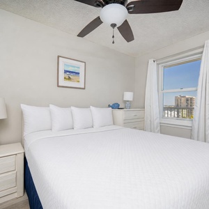 Fluffy pillows invite you to sink into the queen bed in the guest suite after your day along the coast