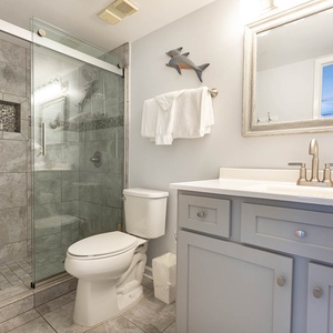 Modern master bath featuring a walk-in shower, stylish gray tiles, and elegant fixtures for a refreshing getaway experience