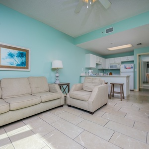 Relax in the spacious living area with comfortable seating, a dining table, and a bright, welcoming atmosphere