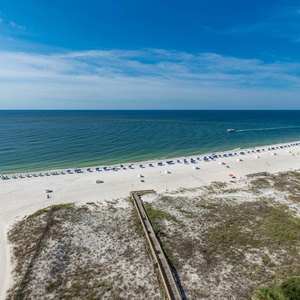 Experience the serene coastline with lounge chairs lining the beach, inviting you to relax and enjoy the view