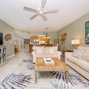 Relax on the comfortable sofas in the living area, surrounded by coastal decor and a welcoming atmosphere