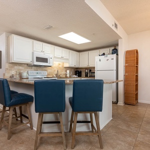 Gather around the kitchen bar with comfortable seating, perfect for casual meals and conversations