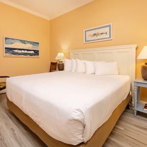 Rest in the king guest suite, surrounded by soft linens, as you unwind and prepare for coastal adventures ahead