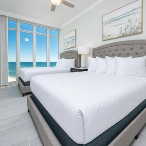 Wake to a breathtaking sunrise in this queen guest suite with two cozy beds and expansive views from the windows