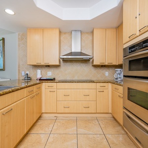Kitchen featuring granite countertops, stainless appliances, and modern cabinetry for a delightful cooking experience