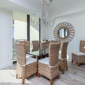 Dine in style at the glass-topped table surrounded by woven chairs, with views of the inviting outdoor space