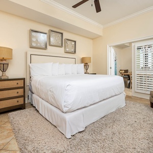 Elegant master bedroom featuring a plush king bed, cozy armchair, and stylish decor for a relaxing getaway