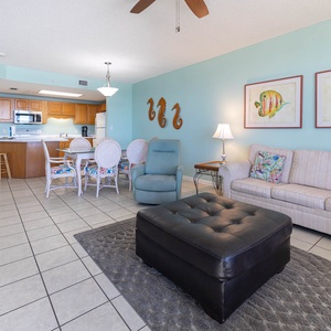 Unwind in the spacious living area featuring colorful decor, sofa with queen sleeper, and a welcoming atmosphere