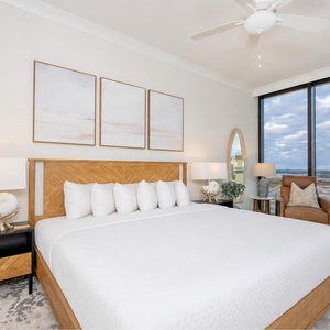 Inviting guest bedroom featuring a king bed, stylish decor, and beautiful beach views