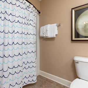 Pamper yourself with plush towels after refreshing showers in this guest bath, adorned with lovely coastal decor