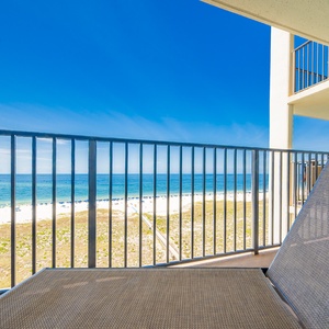 Relax on the balcony while enjoying views of the tranquil gulf and the inviting beach below