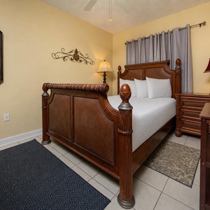 Relax in this charming guest bedroom featuring a decorative queen bed, soft linens, and warm lighting for a restful stay