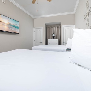 Unwind in this queen guest suite and stream your favorite shows or enjoy a good movie after a beach day