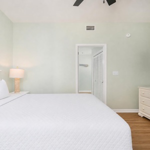 Soft linens invite rest on the king bed in the guest suite as you watch your favorite show on TV