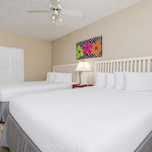Drift into relaxation in the queen guest suite, surrounded by colorful art and the calming vibe of your beach retreat