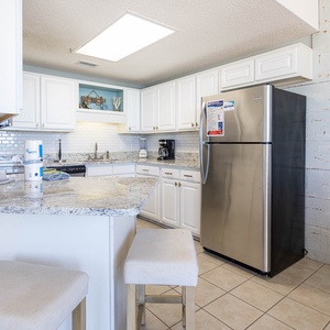 Prepare meals in this inviting kitchen featuring granite countertops, stainless appliances, and elegant design