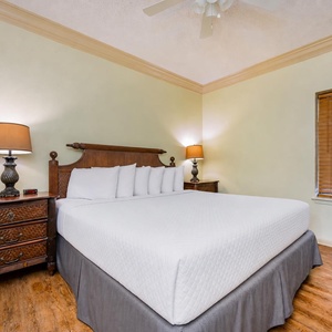 Soft lamps glow warmly beside the king bed in the suite inviting you to unwind after a day of adventure