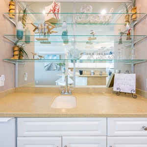 Craft refreshing beverages at the wet bar, enjoying the vibrant beach vibe as you unwind in your coastal retreat