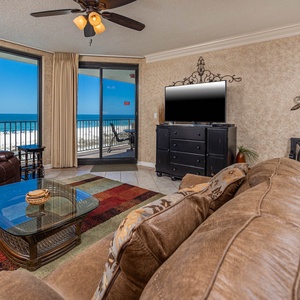 Relax in the inviting living area with plush seating, sofa with queen sleeper, a flat-screen TV, and beachfront views