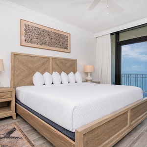 Serene master bedroom featuring a plush king bed with a beachfront view from your balcony
