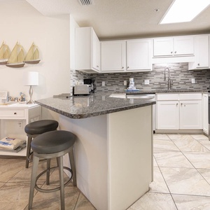 Prepare meals at the stylish kitchen with sleek appliances and a cozy seating area, perfect for casual dining